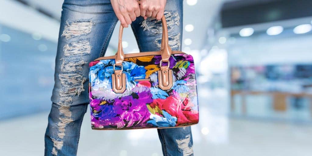 Woman holding brightly colored handbag