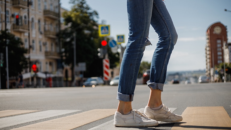 Close up of woman's legs with designer jeans
