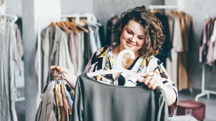 Woman with inverted triangle shape shops for dresses.