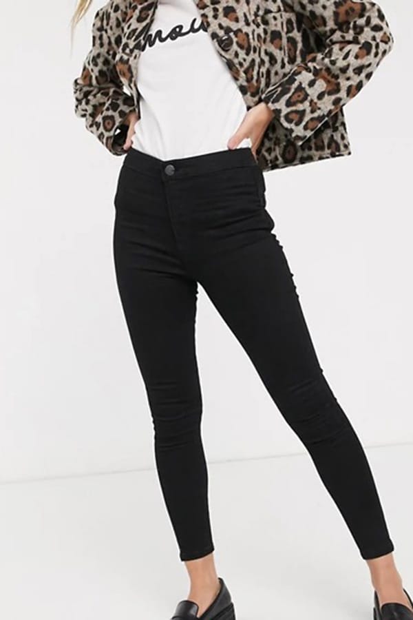 Best jeans for petites: 7 brands to shop now 6 Waist-down view of model wearing black skinny jeans for petites.