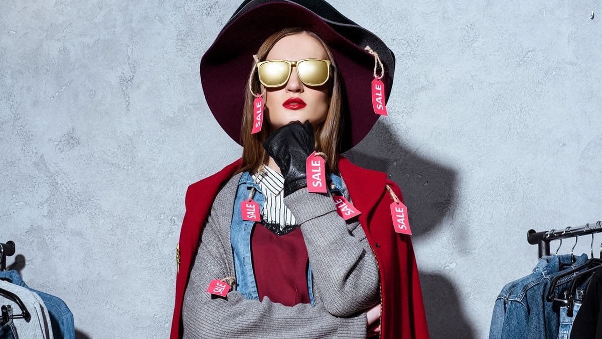 Woman wearing famous maker brands clothes with sale tags