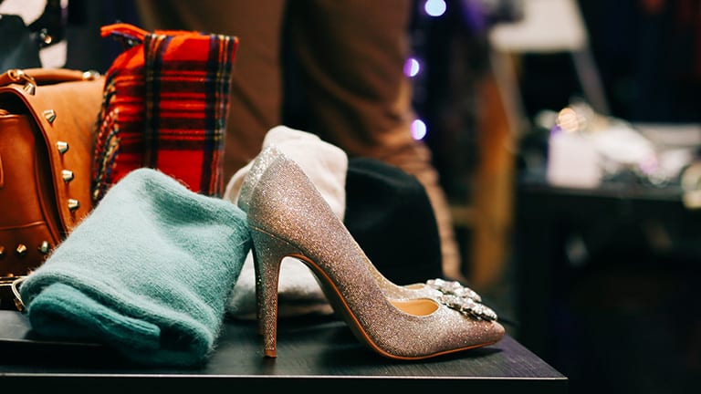 Shoes and clothes on a table, to represent resale shop Redress NYC