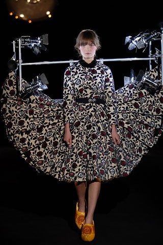 Runway model wearing clogs and spotlights