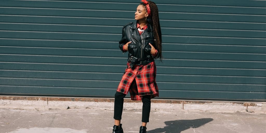 Girl wearing leather jacket and plaid tunic