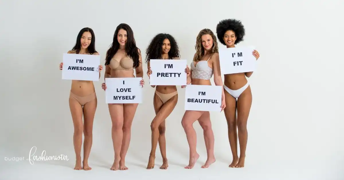 A diverse group of models wearing underwear and holding signs with empowering messages.
