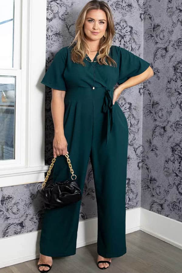 Fall Fashion for Plus Size Fashionistas: 9 Essential Garments to Shop Now 5 Model wears plus-sized jumpsuit in forest green.