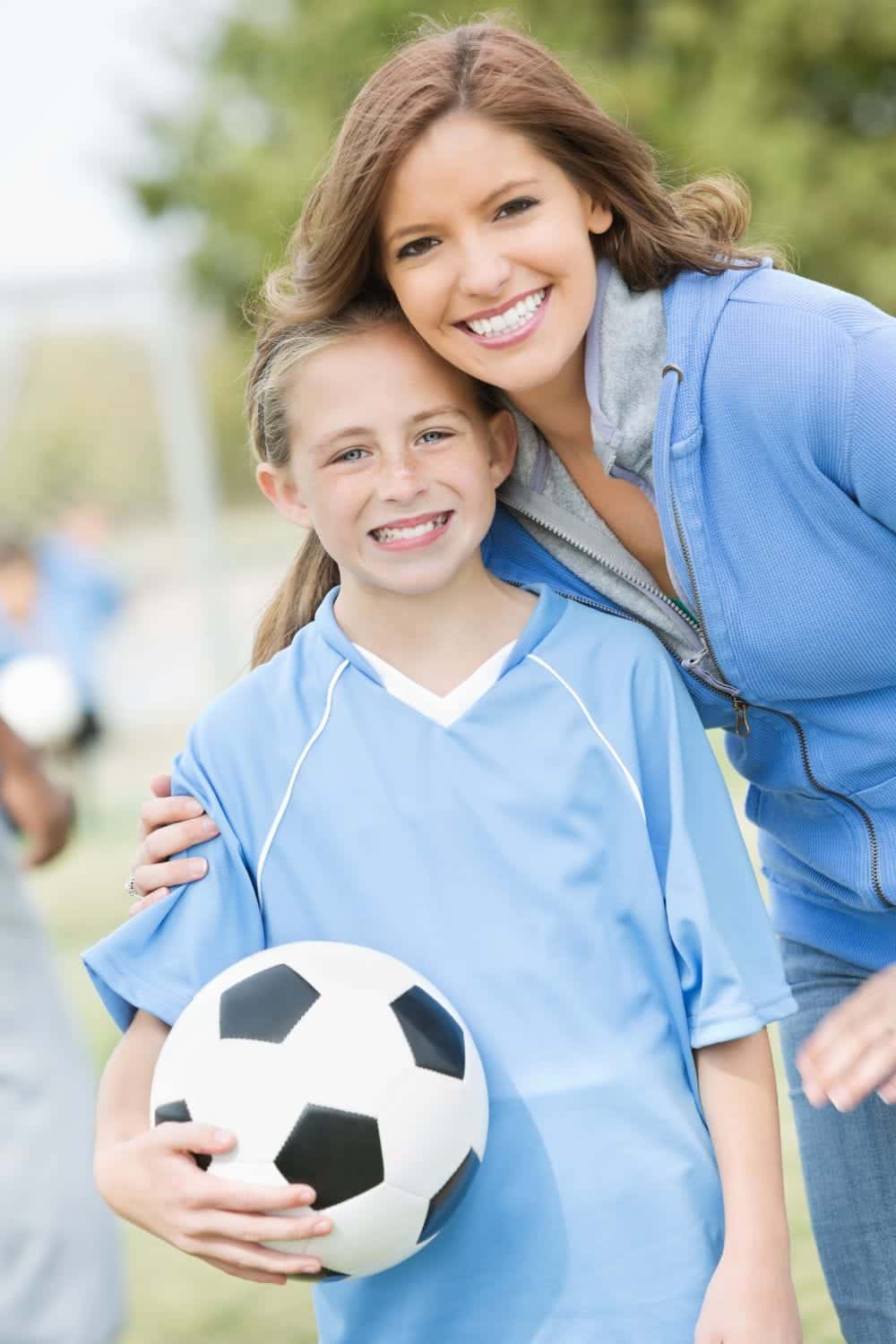11 Brilliant Budget Halloween Costume Ideas 4 Mom with daughter wearing soccer uniform and holding soccer ball.