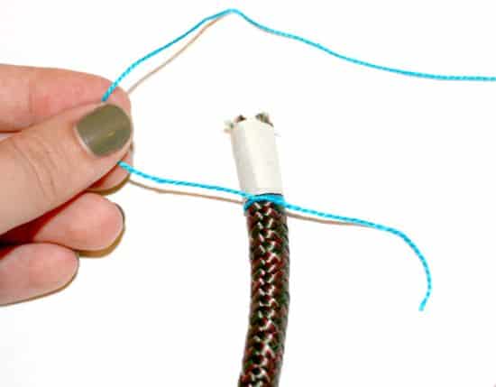Woman wrapping thread around rope