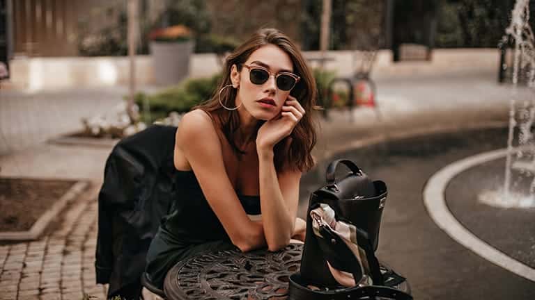 Girl wearing fashionable slip dress and sunglasses.