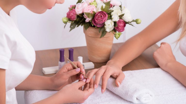 Close up of technician performing manicure