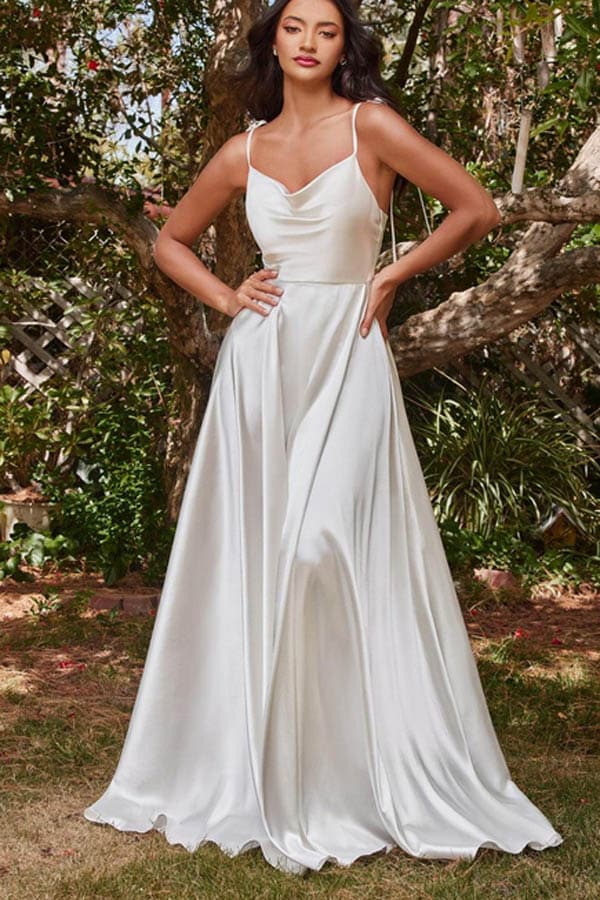 Model wears white satin formal gown with spaghetti straps.