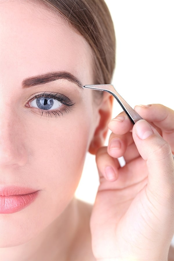 Eyebrows 101: 10 Critical Tips for Grooming, Shaping and Applying Makeup to Your Eyebrows 1 Woman tweezing eyebrows