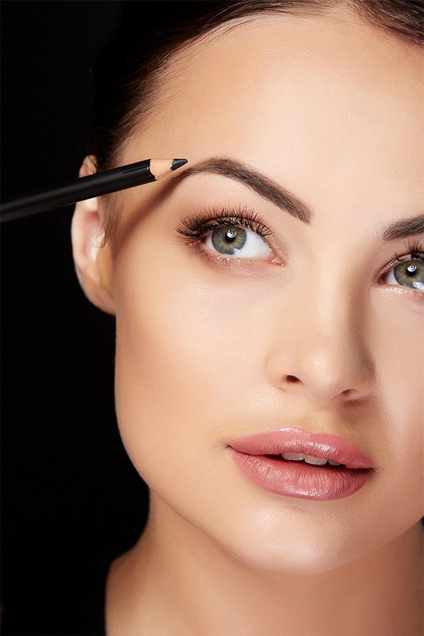 Eyebrows 101: 10 Critical Tips for Grooming, Shaping and Applying Makeup to Your Eyebrows 3 Woman applying eyebrow pencil