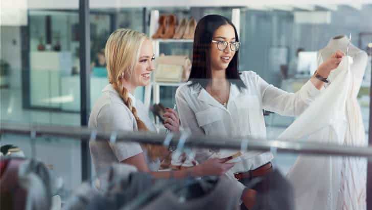 Two women shop in a boutique instead of a big box store.