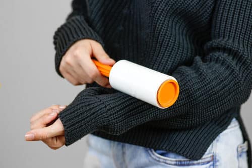 Girl using lint roller