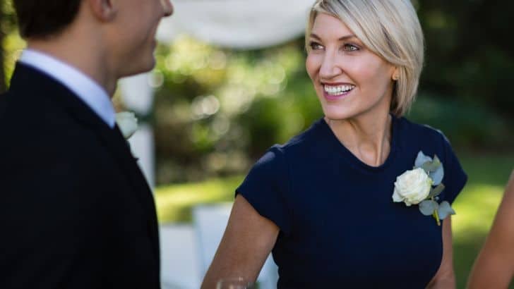 Smiling wedding guest to represent what to wear to a fall wedding.