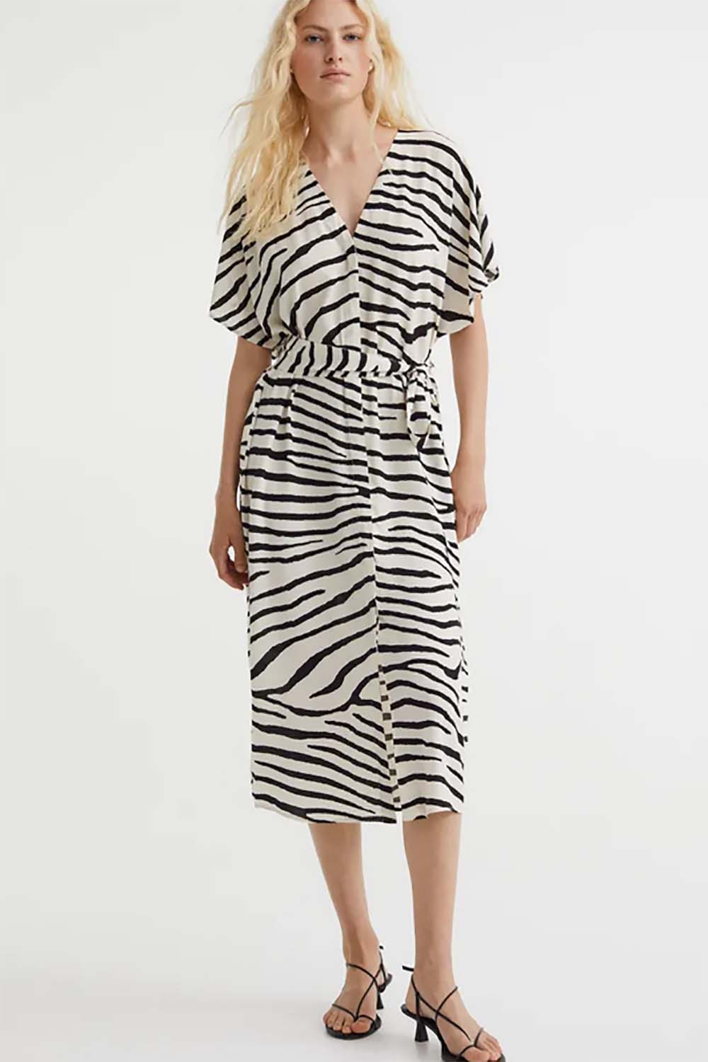 Model wears animal print dress.