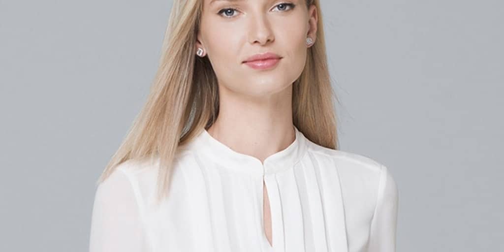 Woman wearing white pleated blouse