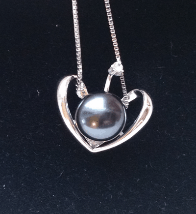 black pearl pendant on black velvet
