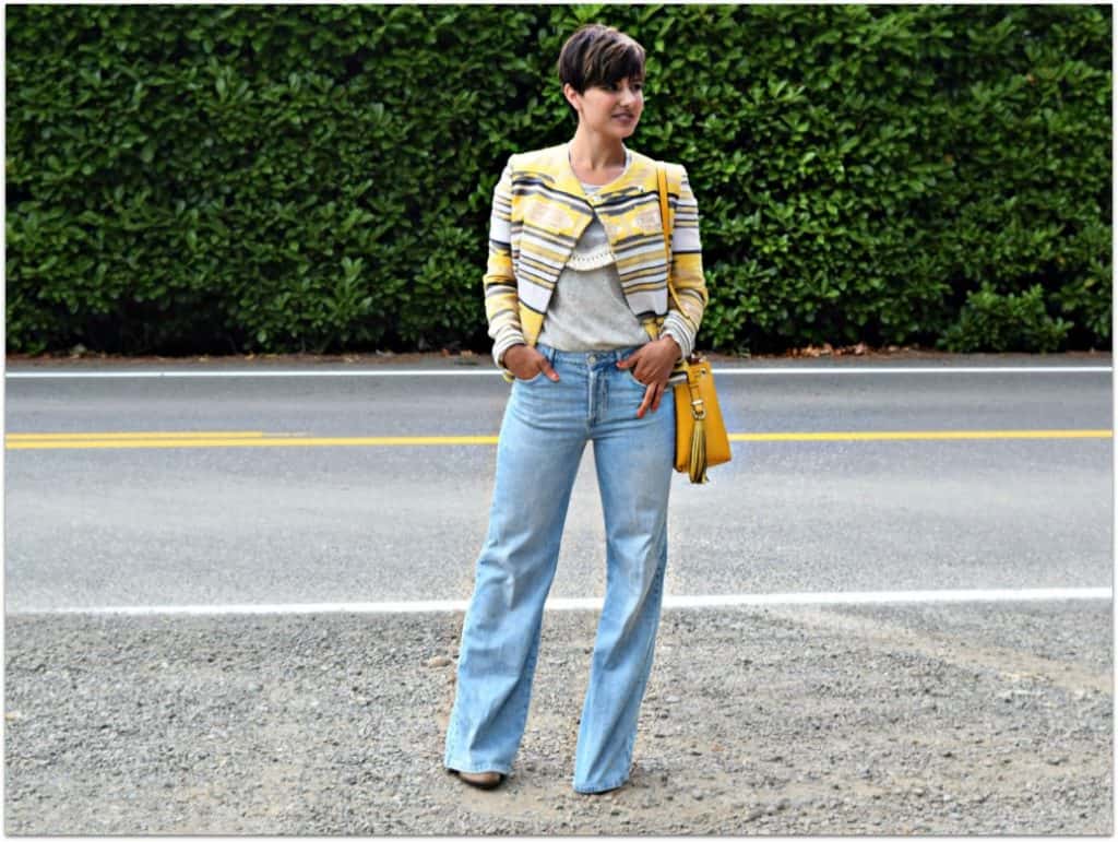 Woman wearing flared jeans and sweater