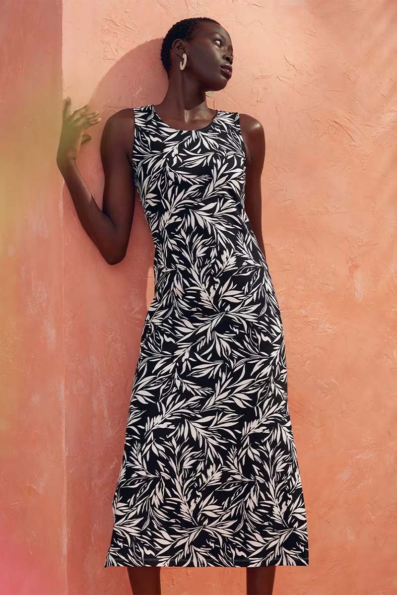 Patterned, sleeveless midi dress, the perfect answer to what to wear to a high school reunion.