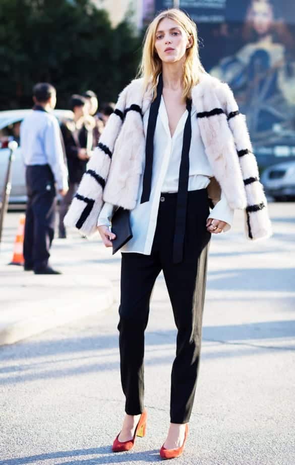Woman wearing skinny scarf and fur coat