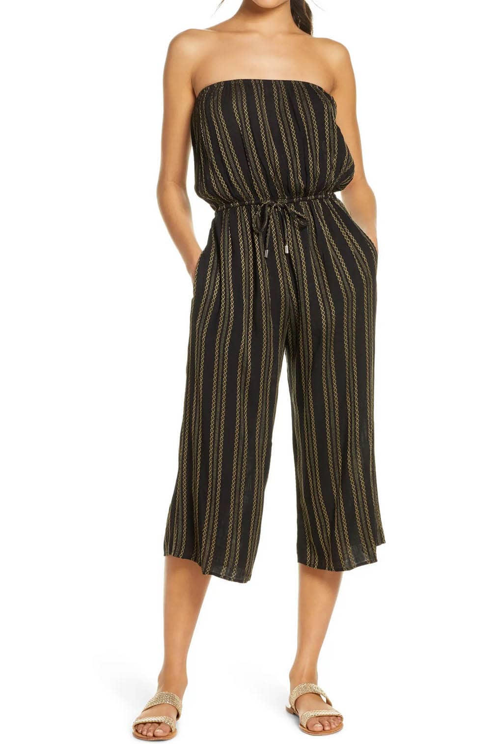 Woman wears sleeveless culotte romper.