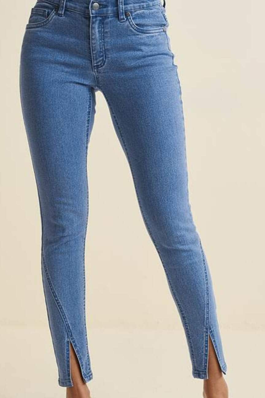 Close up of woman's legs wearing trendy jeans.