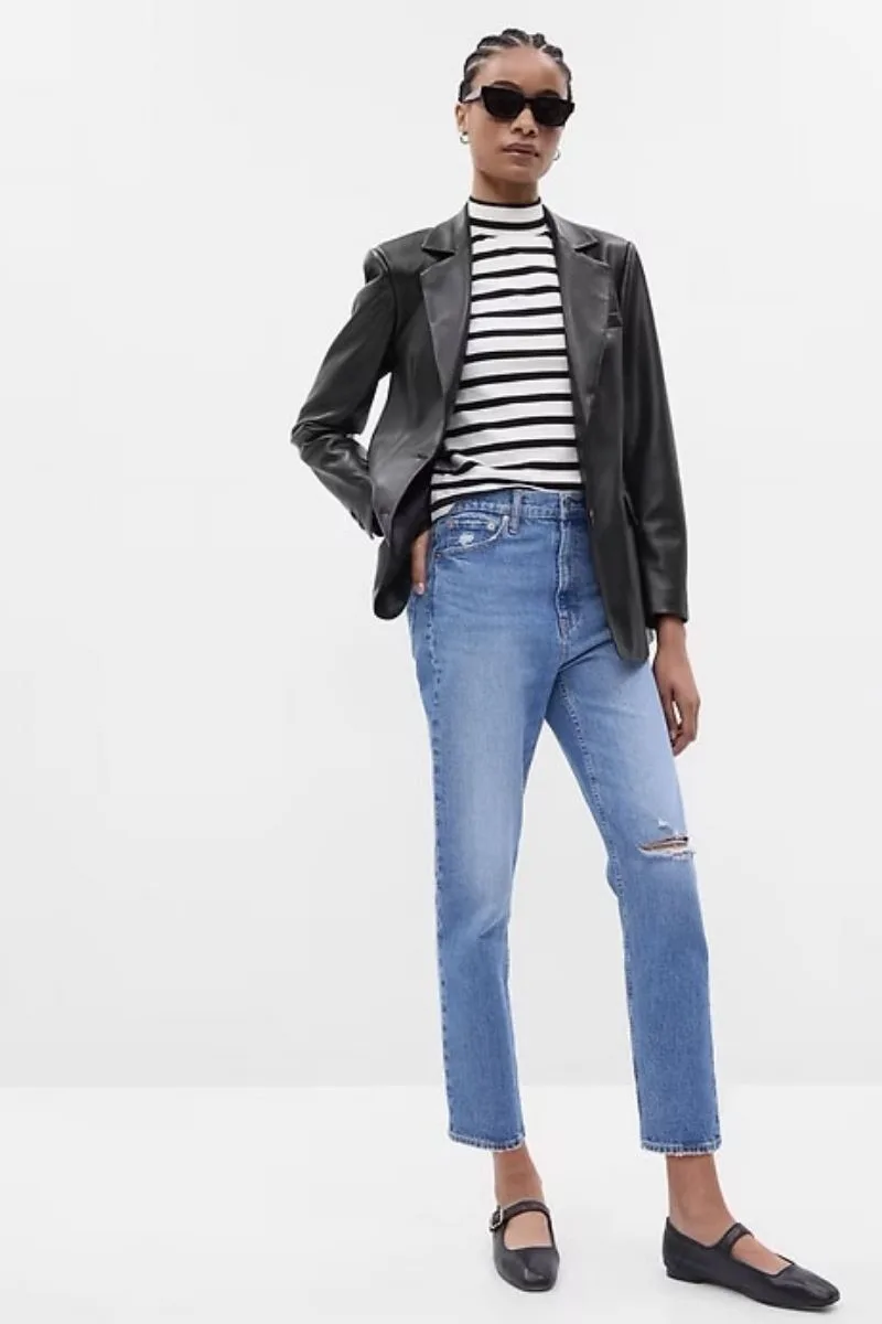Model wears gap leather blazer over jeans and striped top.