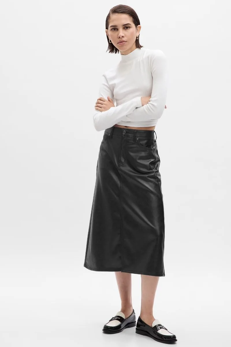 Model wears leather skirt by Gap with crop top.