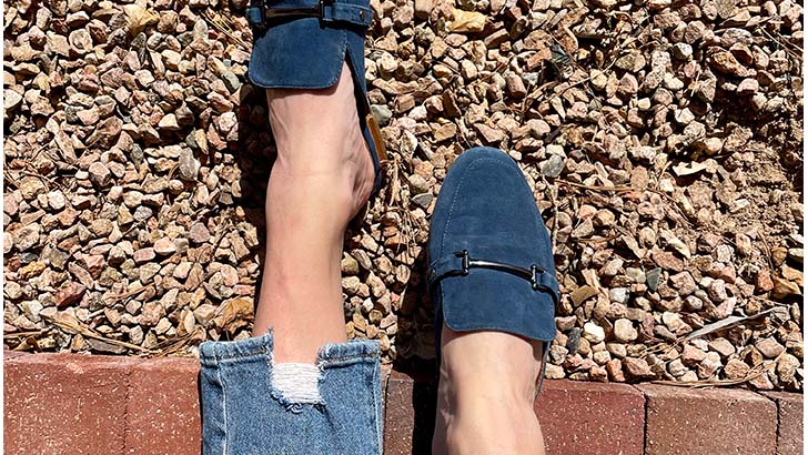 Overhead view of woman's legs wearing mules for fall.