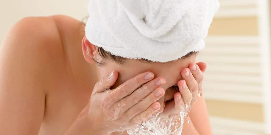 Woman washing her face