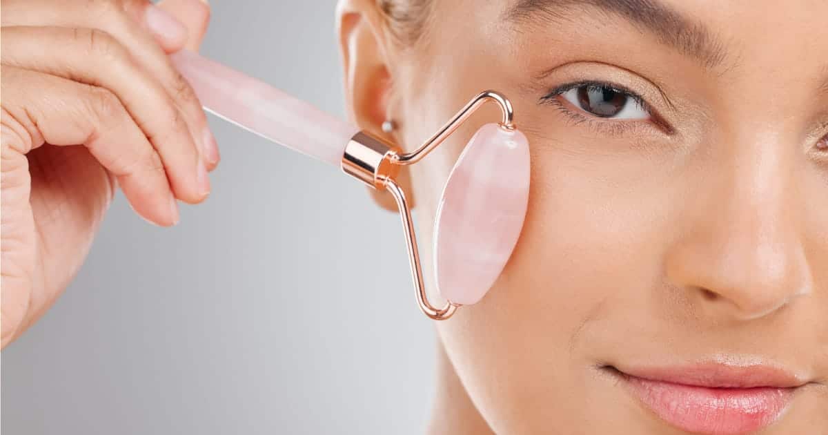 Close up of woman using beauty roller.