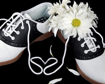 Pair of saddle shoes with a daisy