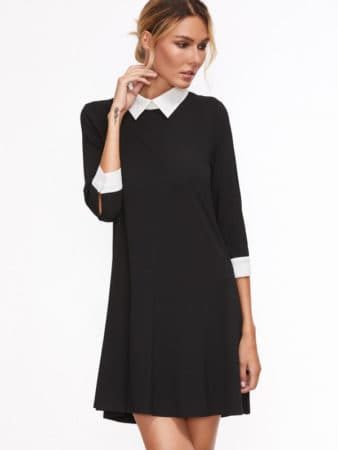 Black swing dress with white cuffs and white collar