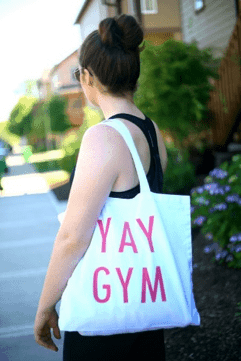 Girl holding canvas tote bag as gym bag