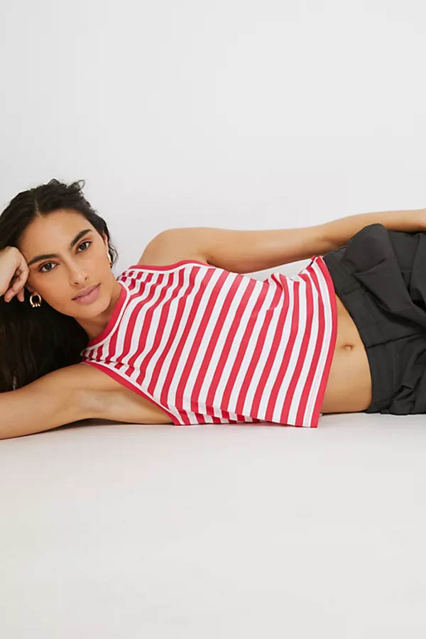 The lying model wears a tank top with red and white stripes.