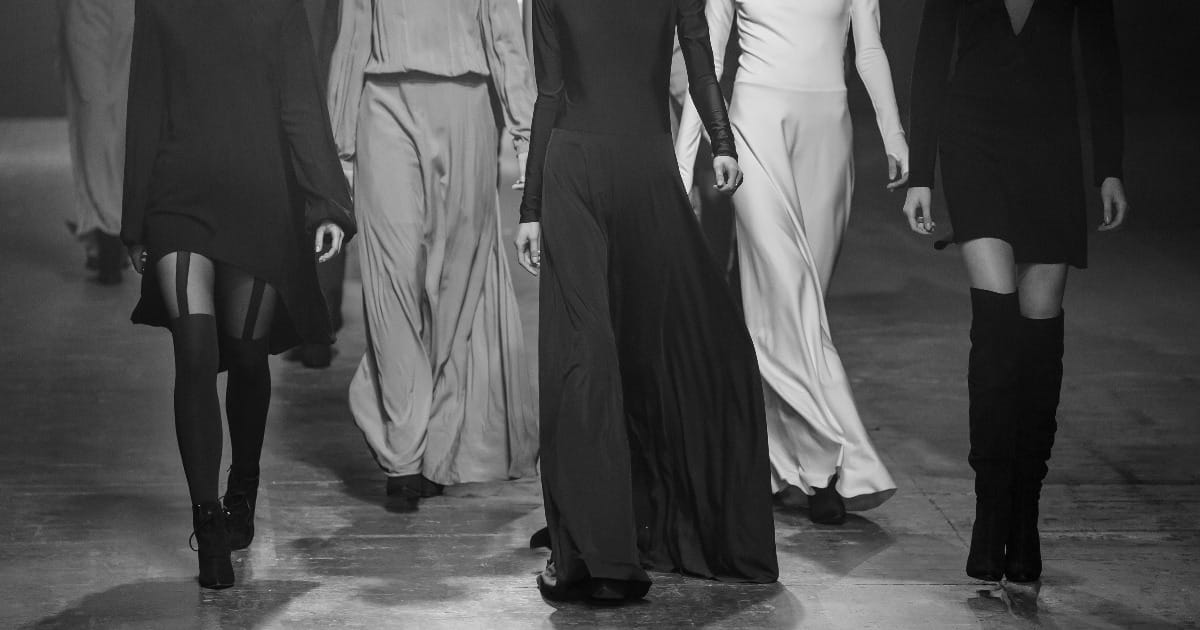 Models walk on runway to represent discount designer clothes and brand names for less.