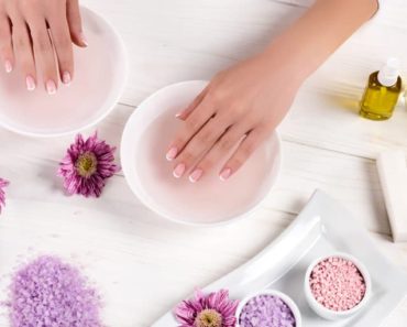 Nail salon table with woman's hands