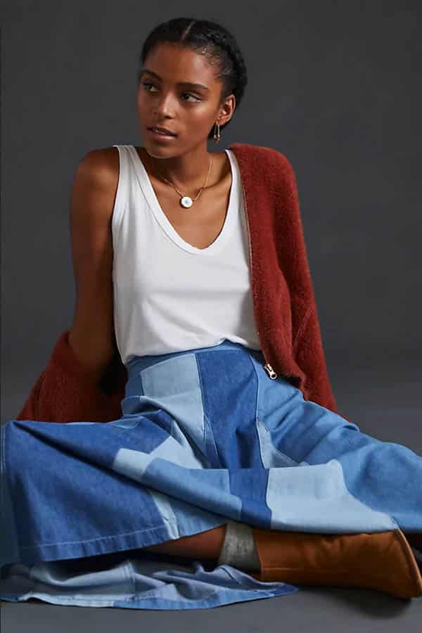 Model wears white tank top, a fall clothing essential.
