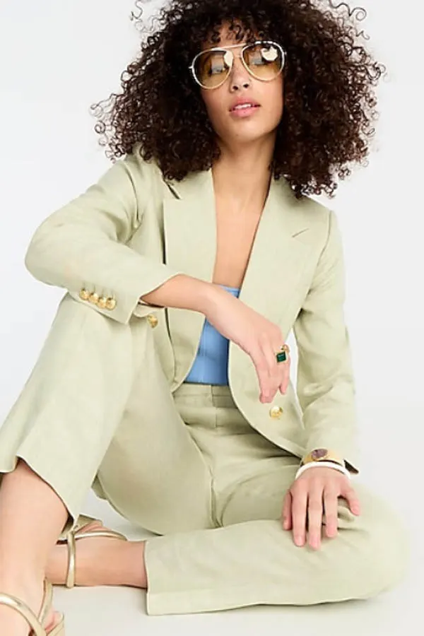 Model wears light green blazer with matching pants.