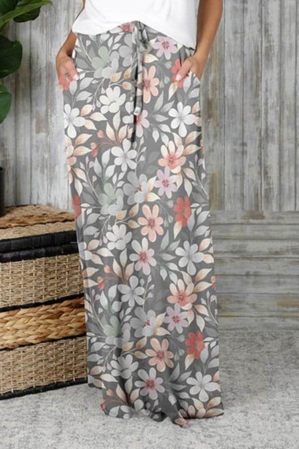 Close up of women's lower half, wearing floral maxi skirt.