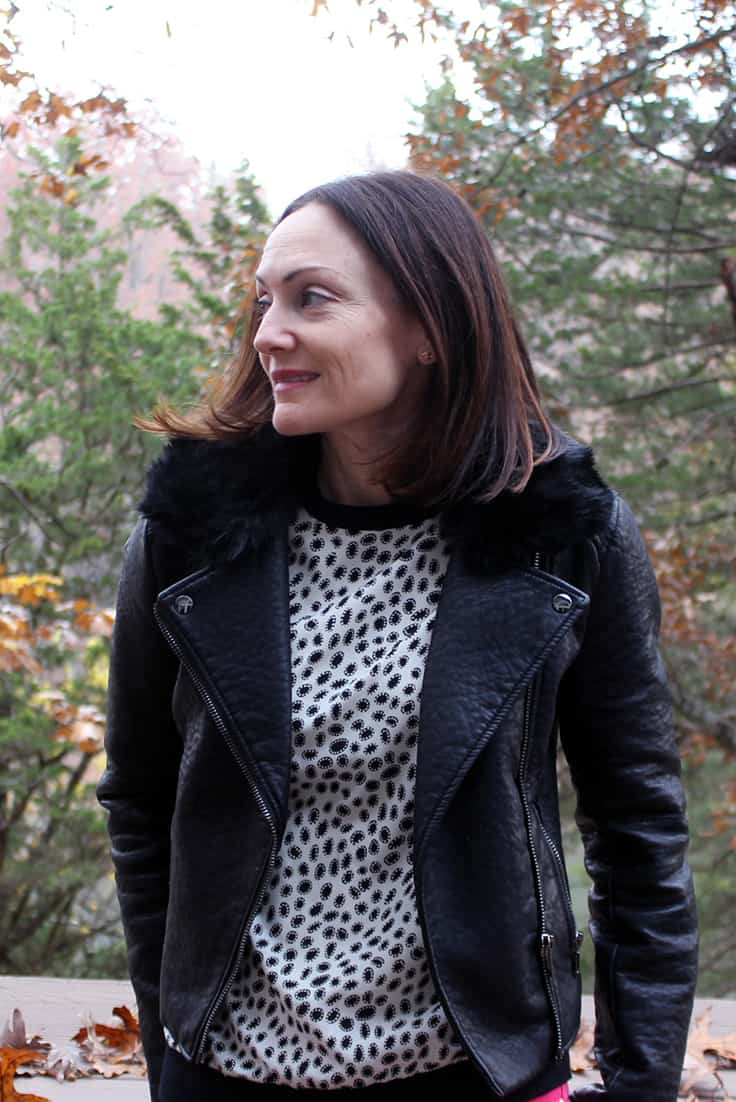 Catherine Brock wearing polka dot top with moto jacket
