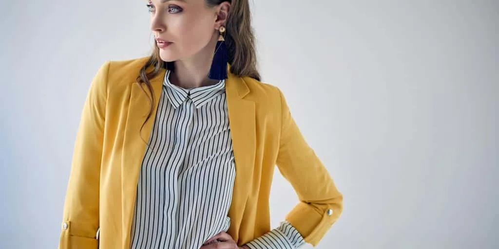 Woman wearing yellow blazer and striped top