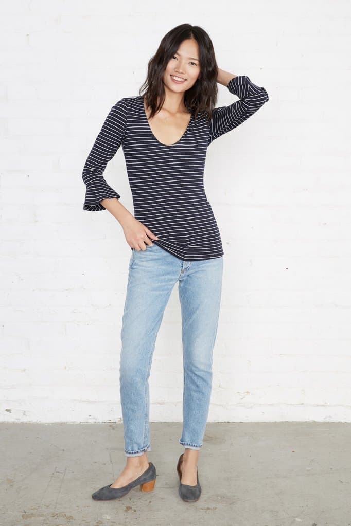 Brunette wearing striped top and jeans