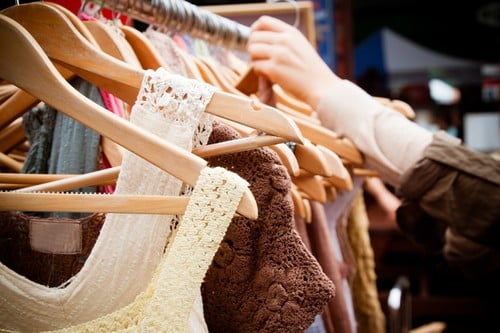 A rack of second-hand women dresses at a market in London: recession bargains.