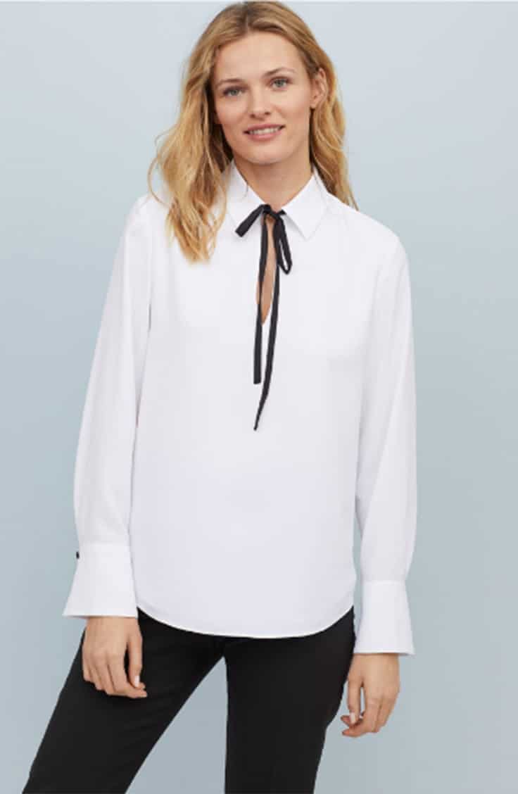 White blouse with black tie at neck