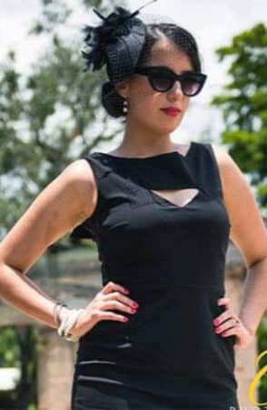 Woman wearing black fascinator hat 