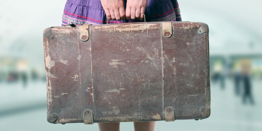 Close up of girl holding suitcase