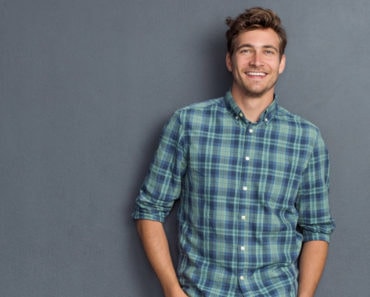 Smiling man wearing plaid shirt